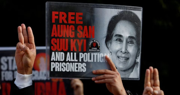 Myanmar protesters residing in Japan show off the portrait of Aung San Suu Kyi and raise three-finger salutes, during a rally to mark the second anniversary of Myanmar's 2021 military coup, outside the Embassy of Myanmar in Tokyo, Japan February 1, 2023. REUTERS/Issei Kato/File Photo