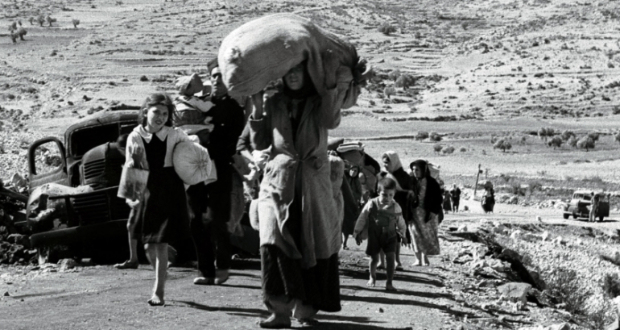 Palestinians carry their possessions on their heads as they flee from a village in Galilee about five months after the creation of the state of Israel in 1948 [File: Reuters]