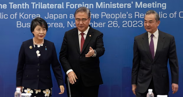 South Korea’s foreign minister, Park Jin, centre, with the Chinese foreign minister Wang Yi, right, and the Japanese foreign minister, Yoko Kamikawa, left, prior to their trilateral meeting in Busan, South Korea. Photograph: Ahn Young-joon/AP