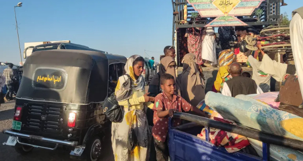 People displaced by the conflict in Sudan walk with their belonging as they flee Wad Madani, the capital of al-Jazirah state, heading to Gadaref state on December 16, 2023 [AFP]