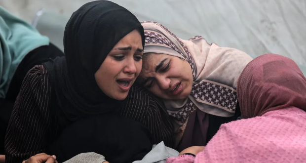 Women at Al-Aqsa hospital in central Gaza mourn their loved ones killed in what Hamas says was an Israeli strike on the Al-Maghazi refugee camp on Sunday