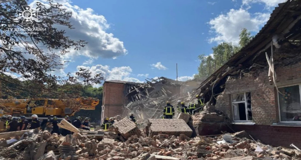 This photo taken and released by the Ukrainian State Emergency Service shows rescuers clearing the debris of a destroyed school following a Russian strike, in the town of Romny, Sumy region on August 23, 2023