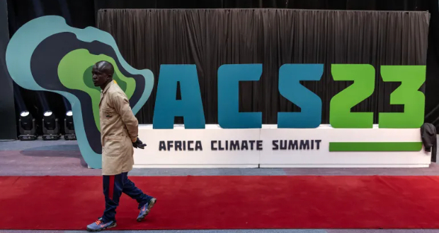 A worker walks past an Africa Climate Summit logo during preparations ahead of the Africa Climate Summit 2023 at the Kenyatta International Convention Centre in Nairobi, Kenya on September 2, 2023 [AFP/Luis Tato]