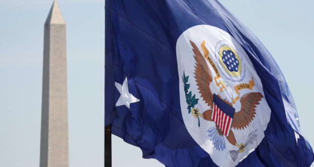 With the Washington Monument behind, the State Department flag flies over its grounds in Washington, US, May 8, 2018. REUTERS/Kevin Lamarque