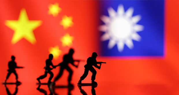 Solider miniatures are seen in front of displayed Chinese and Taiwanese flags in this illustration taken, April 11, 2023. REUTERS/Dado Ruvic/Illustration/File Photo