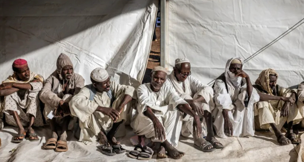Men who have fled the war in Sudan line up during a cash assistance programme at a Transit Centre for refugees in Renk, South Sudan [File: Luis Tato/AFP]
