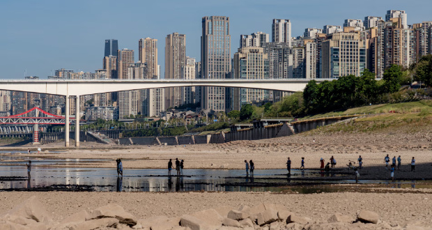 People walk on a dried-out riverbed in Chongqing, China, in August 2022. One study says China is on track for between 20,000 and 80,000 heatwave deaths a year. Photograph: EPA