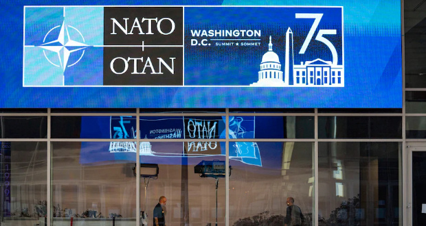 Construction crews assemble fencing around the Walter E. Washington Convention Center on July 6 ahead of the NATO summit in D.C. (Allison Robbert/The Washington Post)